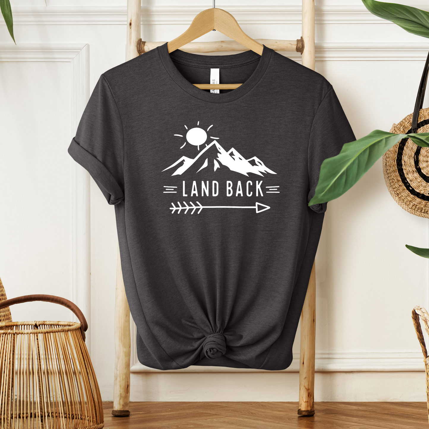 Land Back unisex t-shirt featuring original mountain and sun graphic design symbolizing Indigenous land return movement on soft comfortable cotton tee, perfect for activists and allies.