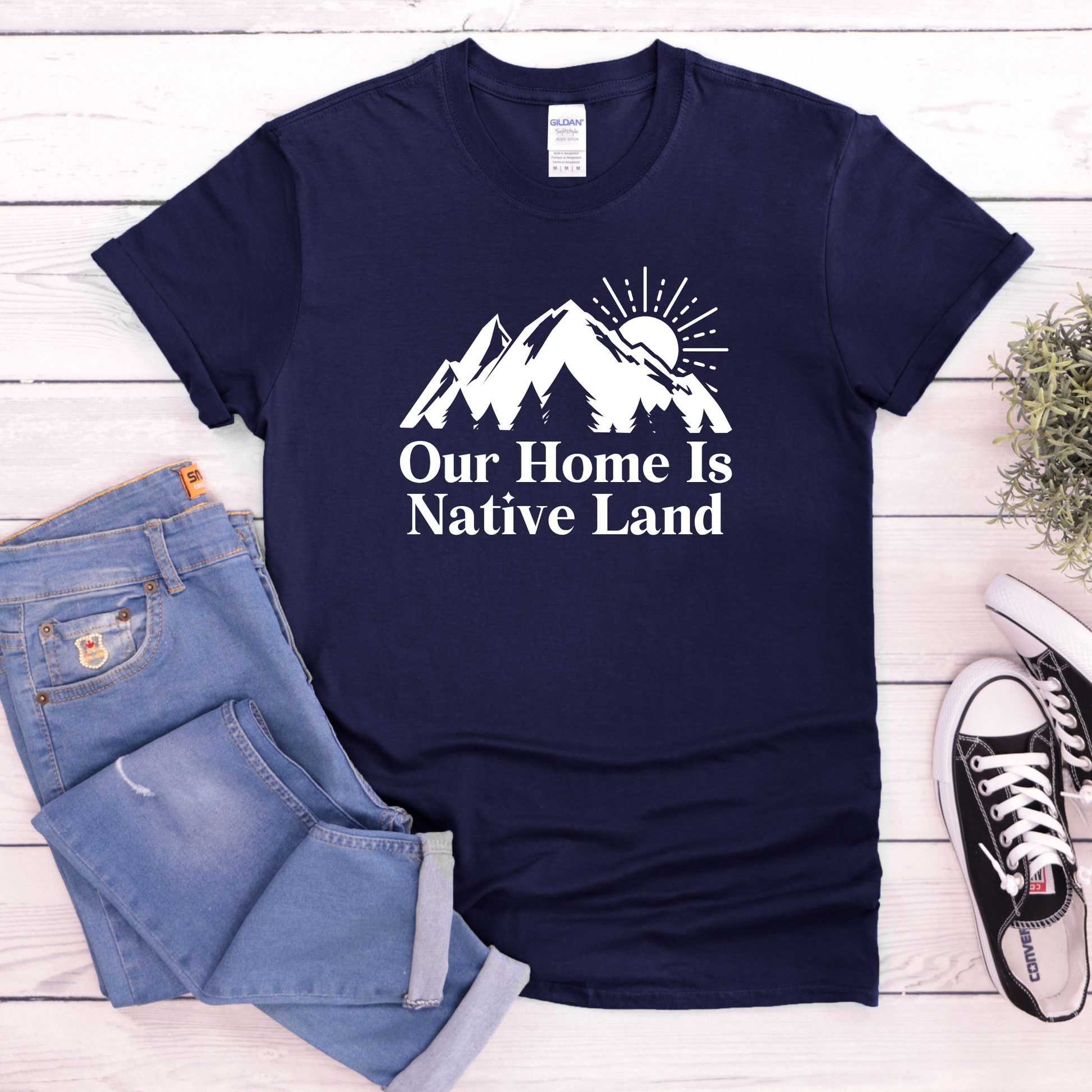 Our Home Is Native Land shirt with white mountain and sunrise graphic on a unisex t-shirt. our home is native land shirt, indigenous pride tee, native pride shirt, indigenous apparel, unisex graphic tee, land acknowledgment shirt, indigenous awareness shirt, statement tee, mountain sunrise shirt, everyday wear shirt, community event shirt, indigenous clothing, native land shirt, meaningful graphic tee, cultural pride shirt