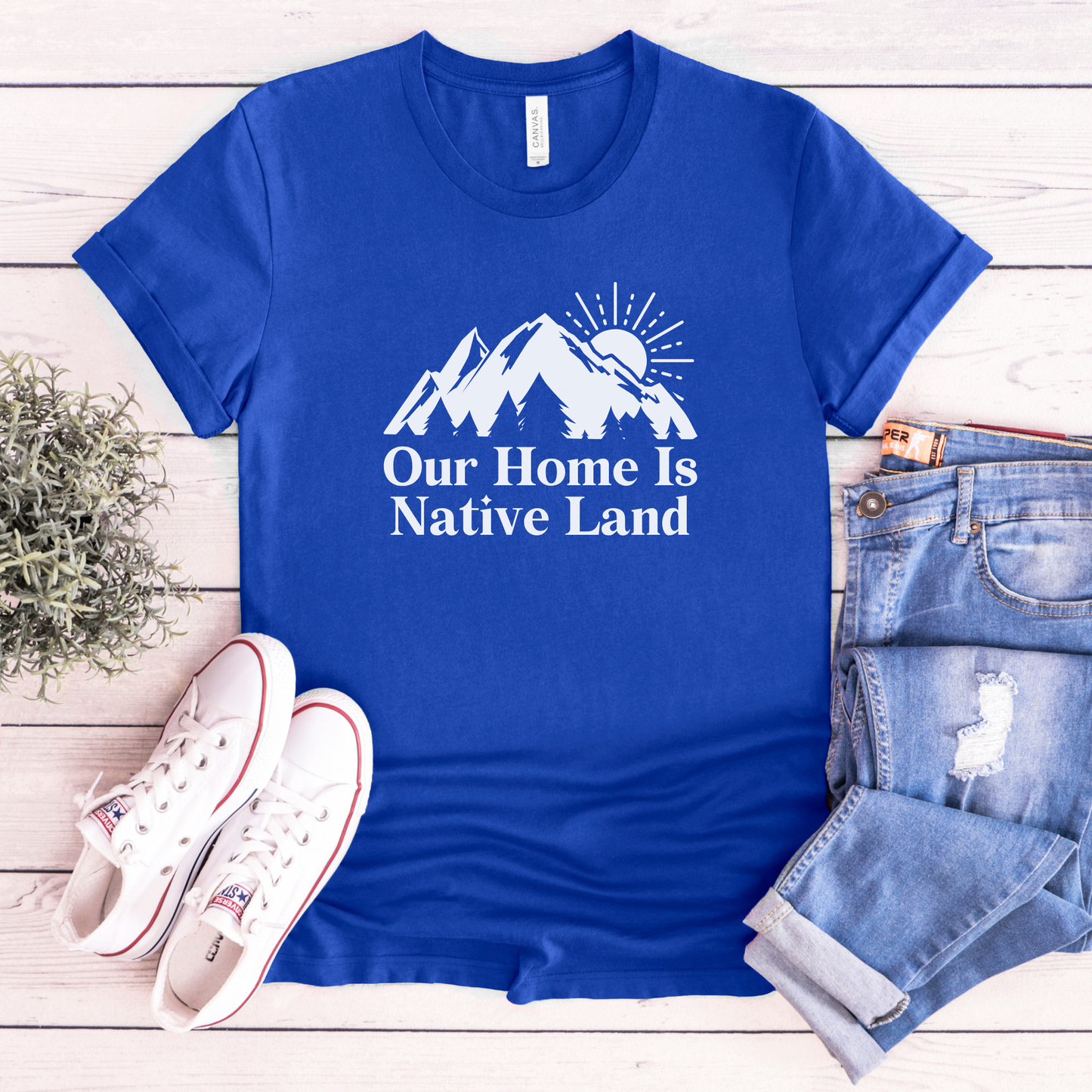 Our Home Is Native Land shirt with white mountain and sunrise graphic on a unisex t-shirt. our home is native land shirt, indigenous pride tee, native pride shirt, indigenous apparel, unisex graphic tee, land acknowledgment shirt, indigenous awareness shirt, statement tee, mountain sunrise shirt, everyday wear shirt, community event shirt, indigenous clothing, native land shirt, meaningful graphic tee, cultural pride shirt