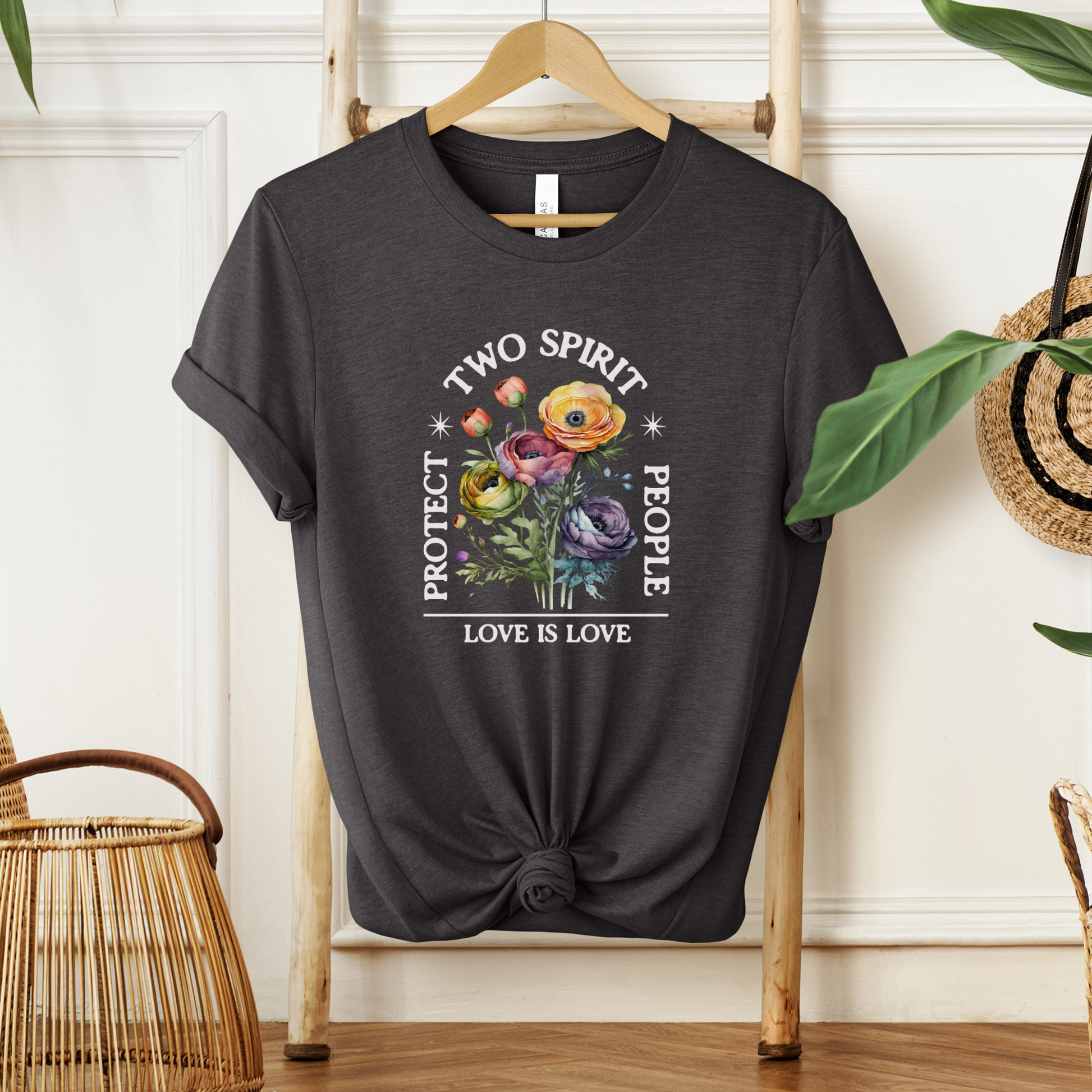 Black t-shirt with 'Two Spirit People, Love is Love' design on a wooden hanger. protect two spirit people shirt, love is love two spirit tee, indigenous lgbtq shirt, two spirit pride t-shirt, indigenous pride apparel, lgbtq indigenous tee, two spirit advocacy shirt, love is love unisex tee, 2s pride shirt, indigenous lgbtq clothing, two spirit protection tee, queer indigenous apparel