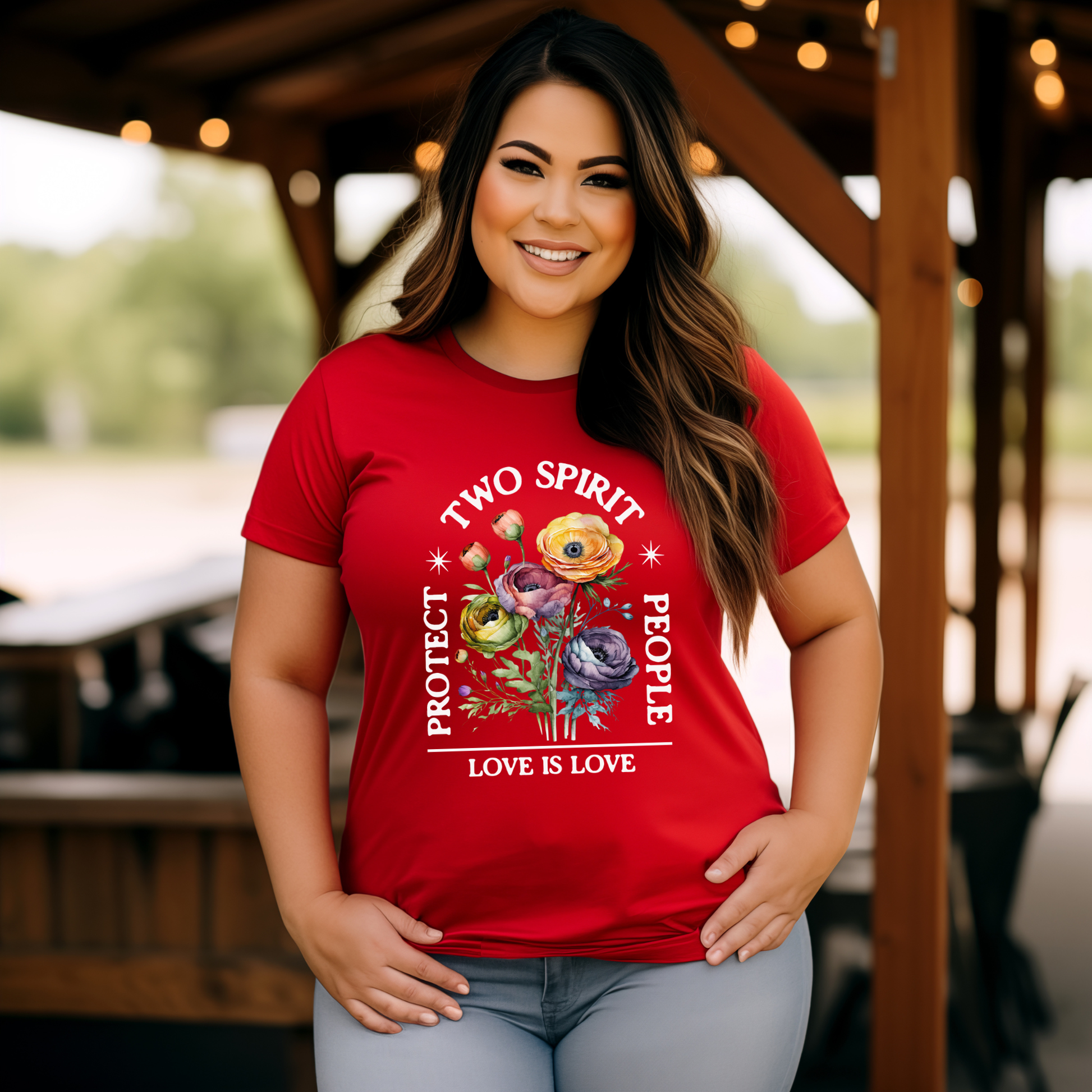 Woman wearing a red t-shirt with 'Two Spirit People Love is Love' design outdoors. protect two spirit people shirt, love is love two spirit tee, indigenous lgbtq shirt, two spirit pride t-shirt, indigenous pride apparel, lgbtq indigenous tee, two spirit advocacy shirt, love is love unisex tee, 2s pride shirt, indigenous lgbtq clothing, two spirit protection tee, queer indigenous apparel