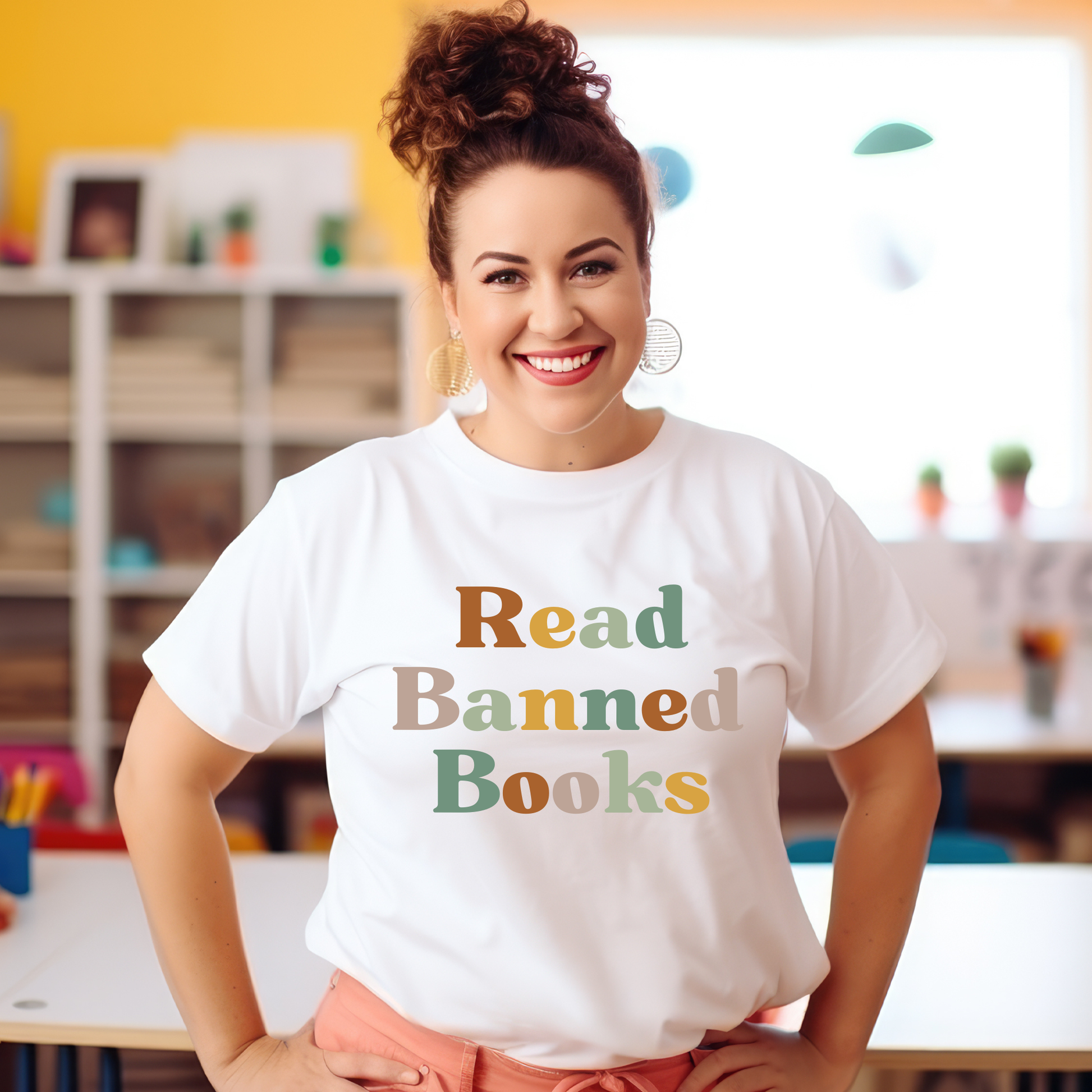 Woman wearing a white t-shirt with 'Read Banned Books' text in a classroom setting. read banned books shirt, banned books tee, book lover shirt, librarian shirt, teacher book shirt, freedom to read shirt, literary shirt, bookish apparel, reading shirt, library activism shirt, anti censorship shirt, intellectual freedom tee, book club shirt, educational shirt, reader gift shirt