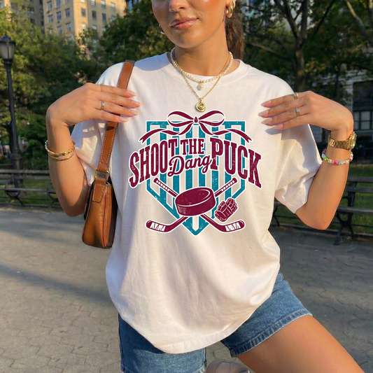 shoot the puck shirt, hockey graphic tee, coquette hockey shirt, hockey bow shirt, trendy hockey shirt, hockey mom shirt, hockey fan shirt, cute hockey shirt, aesthetic hockey tee, hockey sticks shirt, puck shirt, game day hockey outfit, sporty chic shirt, womens hockey shirt, unisex hockey tee