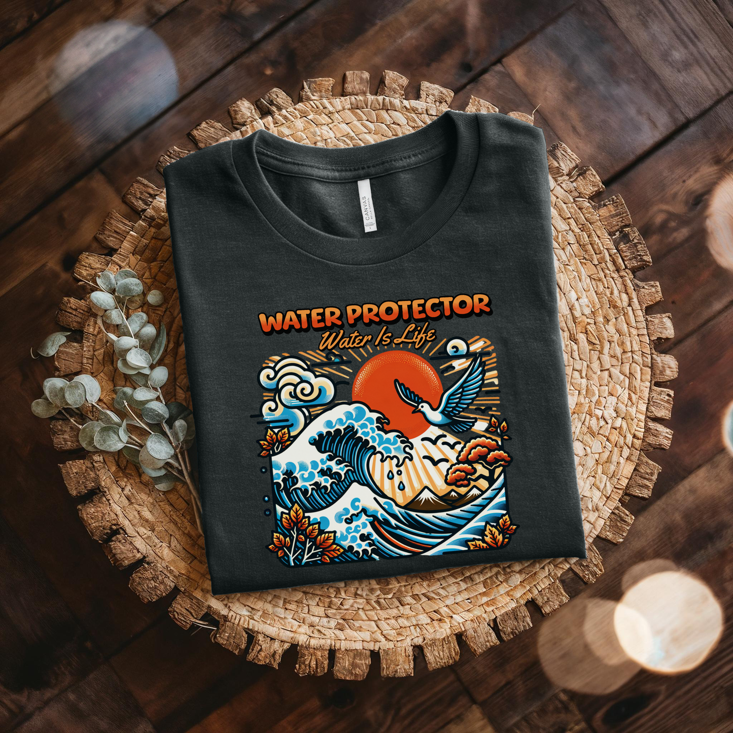 t-shirt featuring a colorful "Water Protector – Water Is Life" graphic with ocean waves, birds, mountains, autumn leaves, and a vibrant sunset, symbolizing environmental stewardship and respect for water. water protector shirt, water is life t-shirt, indigenous environmental apparel, protect our water shirt, environmental awareness tee, sustainability shirt, indigenous advocacy clothing, water stewardship apparel, activist graphic tee, nature lover t-shirt, earth day apparel, eco conscious clothing, environ