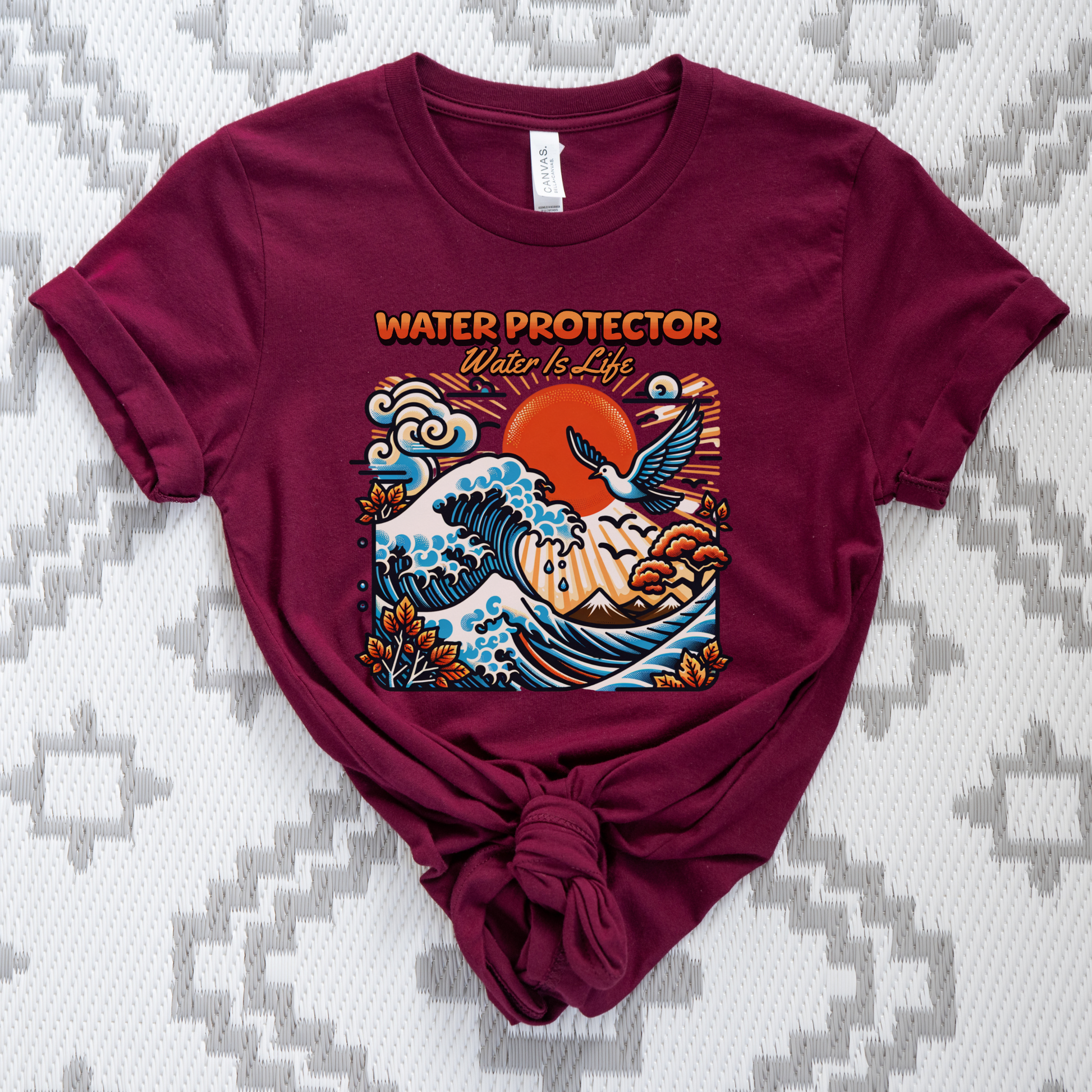 t-shirt featuring a colorful "Water Protector – Water Is Life" graphic with ocean waves, birds, mountains, autumn leaves, and a vibrant sunset, symbolizing environmental stewardship and respect for water. water protector shirt, water is life t-shirt, indigenous environmental apparel, protect our water shirt, environmental awareness tee, sustainability shirt, indigenous advocacy clothing, water stewardship apparel, activist graphic tee, nature lover t-shirt, earth day apparel, eco conscious clothing, environ